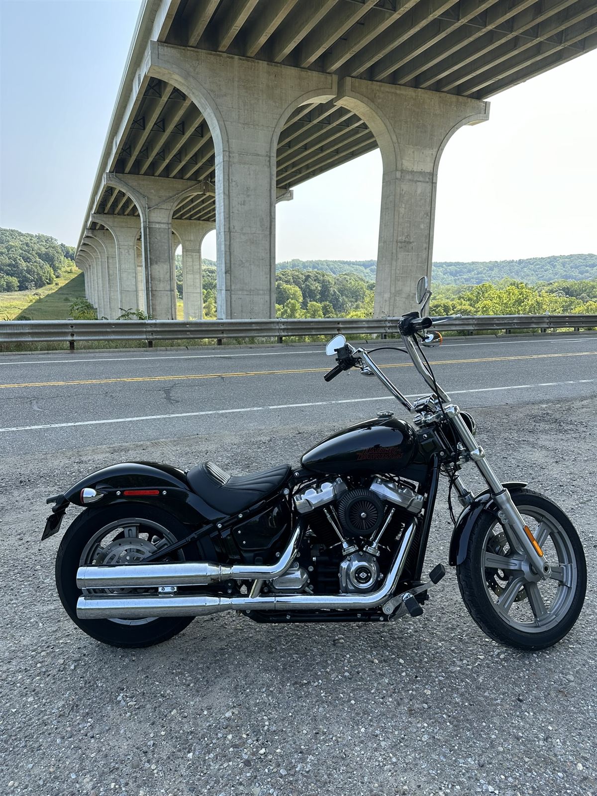 Black Harley-Davidson Softail Standard with tall ape hanger handlebars parked beneath the Route 82 viaduct in the Cuyahoga Valley, Ohio